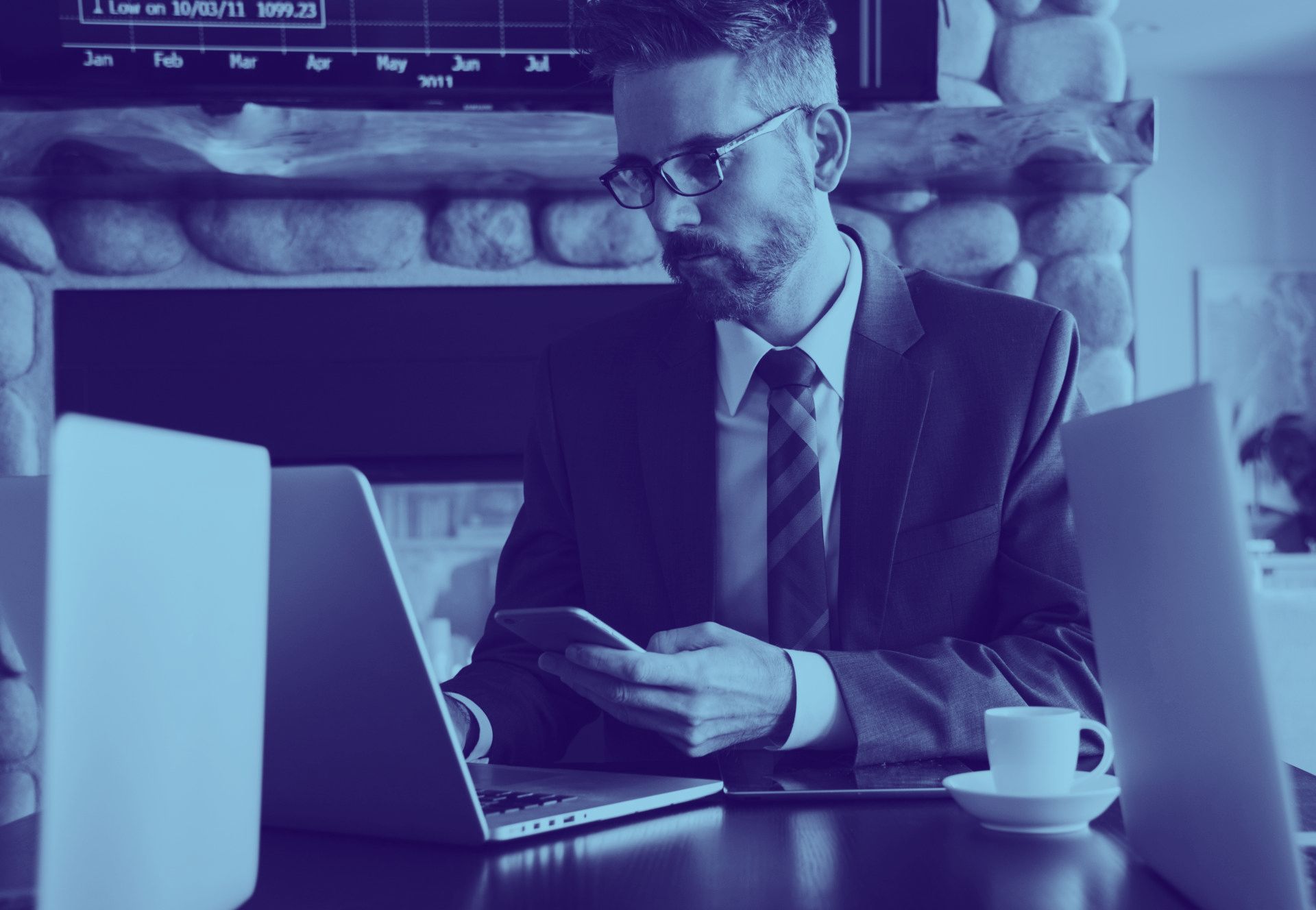 Business professional working beside a laptop